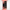 Black cylindrical Wash GEC RGBW wall sconce mounted on a white wall, emitting red light upward and downward.